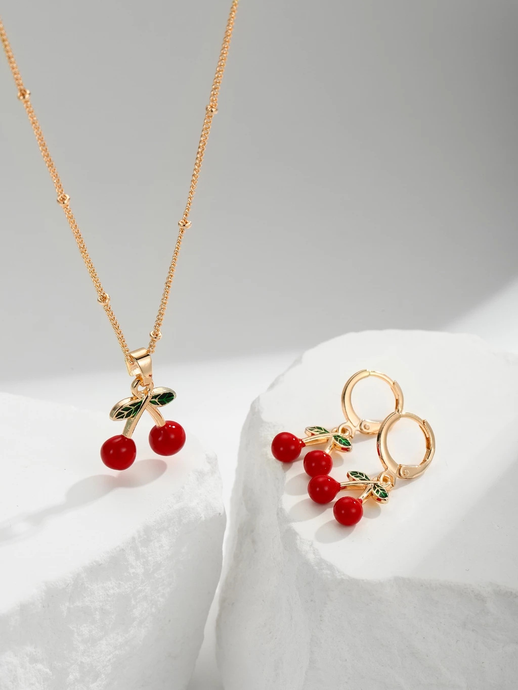 Explosiones transfronterizas coloridas cereza roja pintada a mano goteo de frutas series de joyería simple colgante de viento conjunto de aretes collar