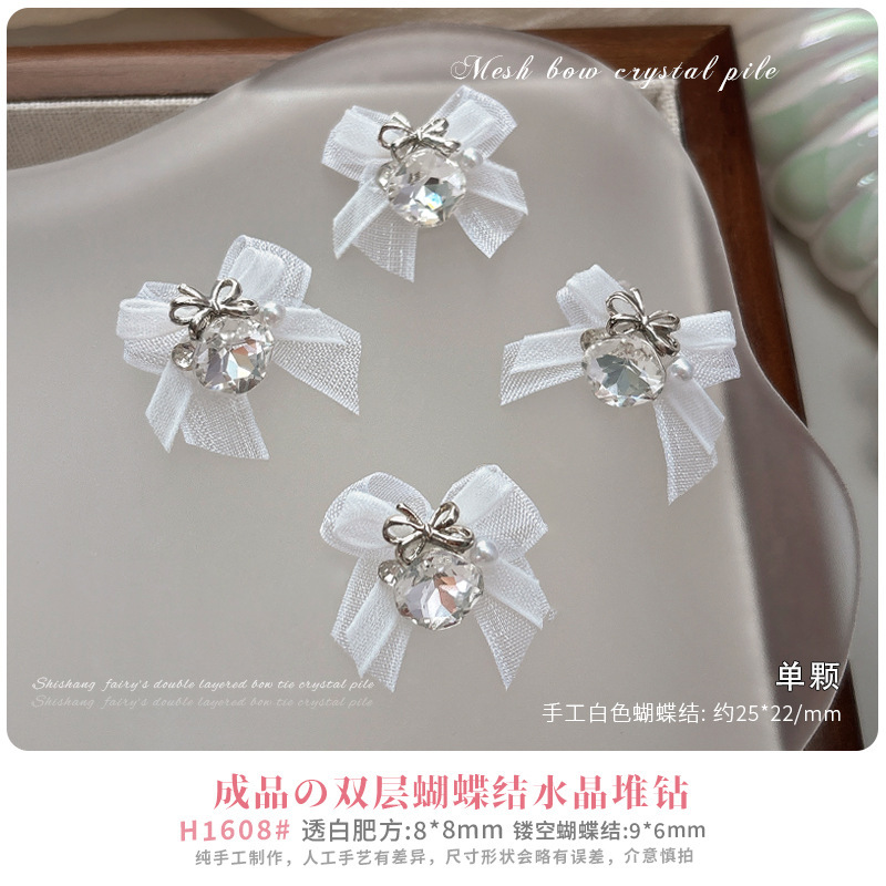 欧根紗の蝶結びの山のドリルのネイルアクセサリーの新型の純白のピンクの蝶結びの完成品の大きいダイヤモンドのネットの赤い爆発金|undefined