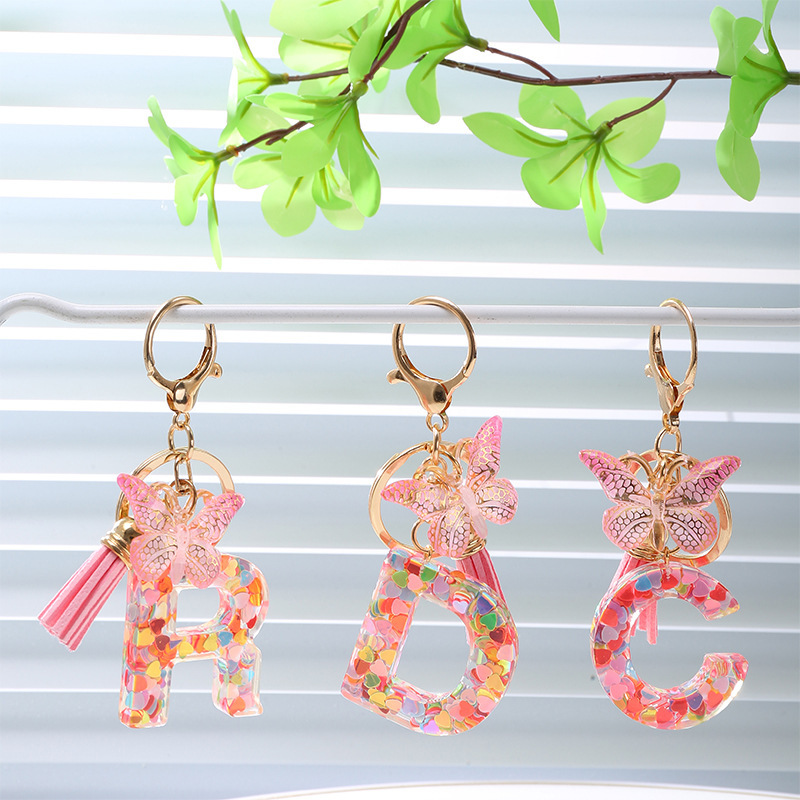 Cross-border popular resin letter sequin keychain with cartoon bow and tassel pendant for couples' backpacks, wholesale