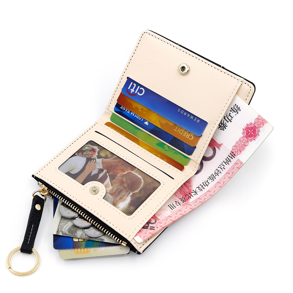 Versión coreana de la nueva billetera corta para mujer, llavero simple, billetera de monedas, billetera de dos pliegues para estudiantes al por mayor