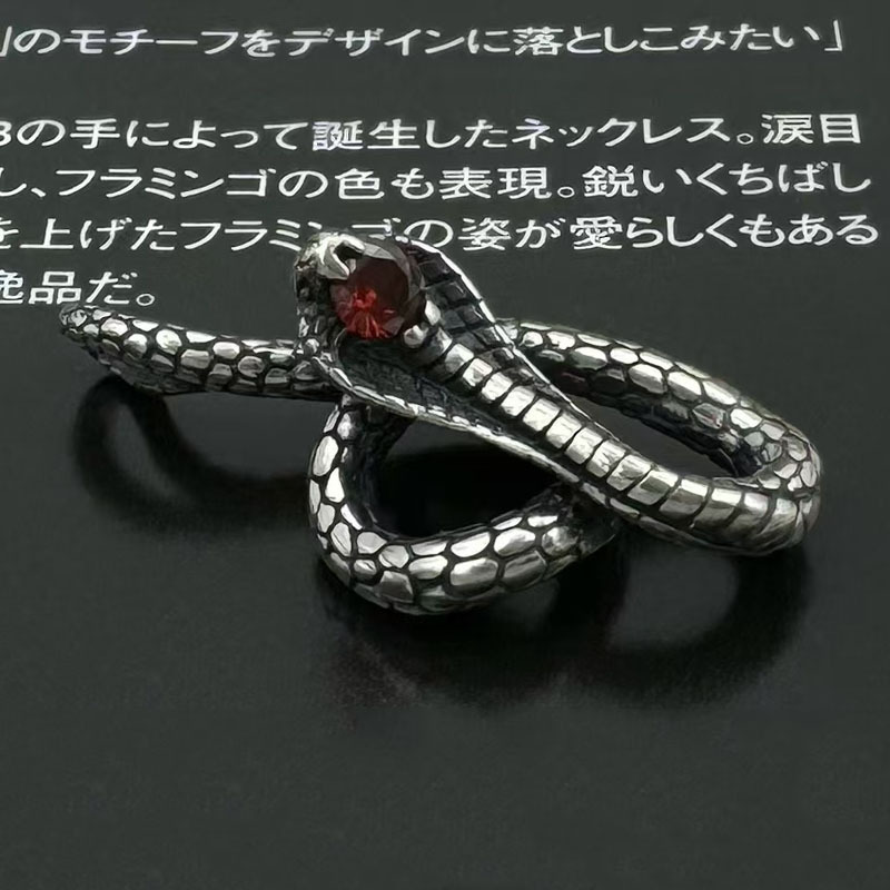 Side view of the cobra pendant showing its 3D coiled shape