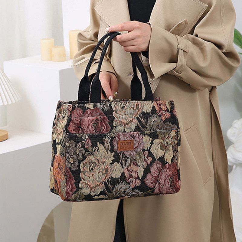 This retro handbag features a tote flower oil painting style. It's convenient to carry a lunch box to work. It has a large capacity and is a mommy bag for going out undefined