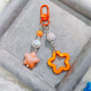 Door buckle G05 new glitter hollow acrylic five-pointed star car key chain pendant cream two-color bell matching
