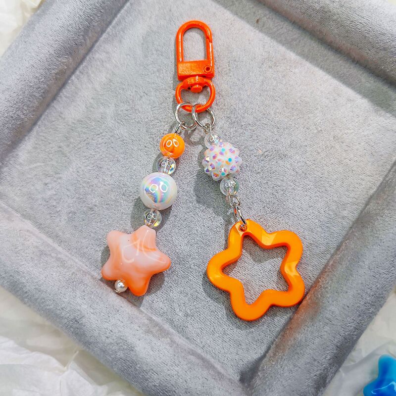 Door buckle G05 new glitter hollow acrylic five-pointed star car key chain pendant cream two-color bell matching Door buckle G05 new glitter hollow acrylic five-pointed star car key chain pendant cream two-color bell matching