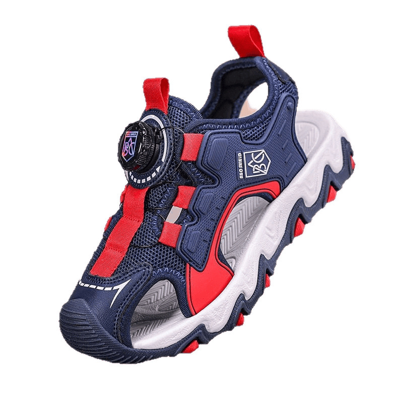 Verano 2025 nuevo estilo sandalias de malla hueca para niños zapatos de playa Baotou botones giratorio sandalias deportivas para niños de suela suave