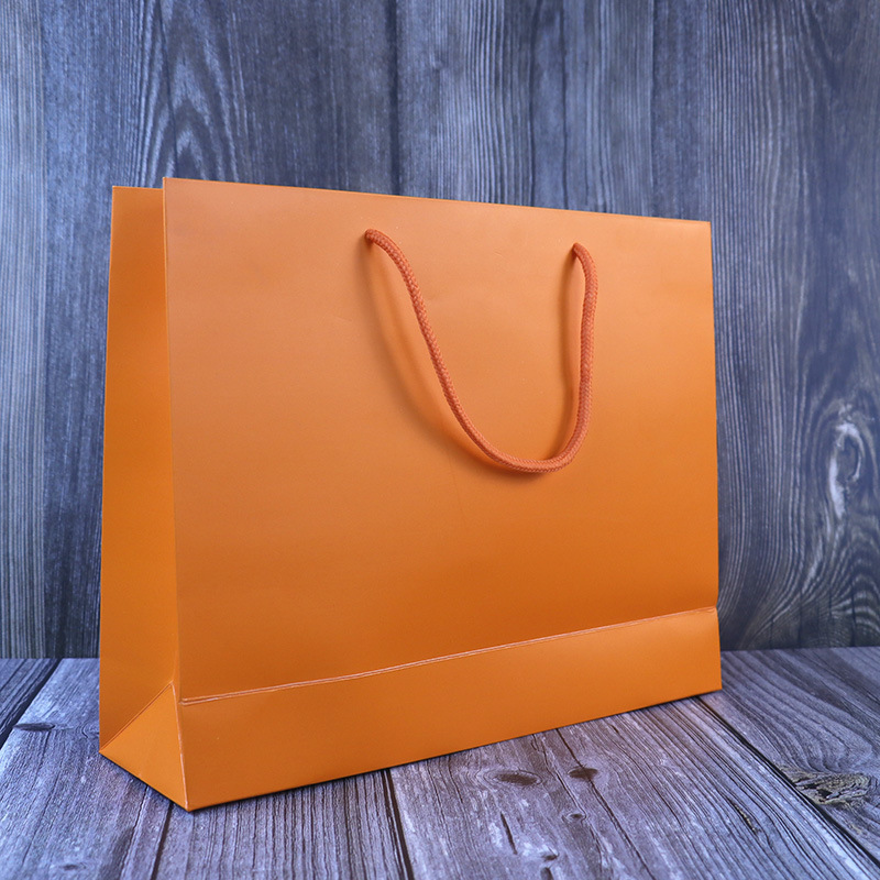 Clothes shop shopping paper bag printed logo fashion big brand handbag trendy orange simple kraft paper gift bag Clothes shop shopping paper bag printed logo fashion big brand handbag trendy orange simple kraft paper gift bag