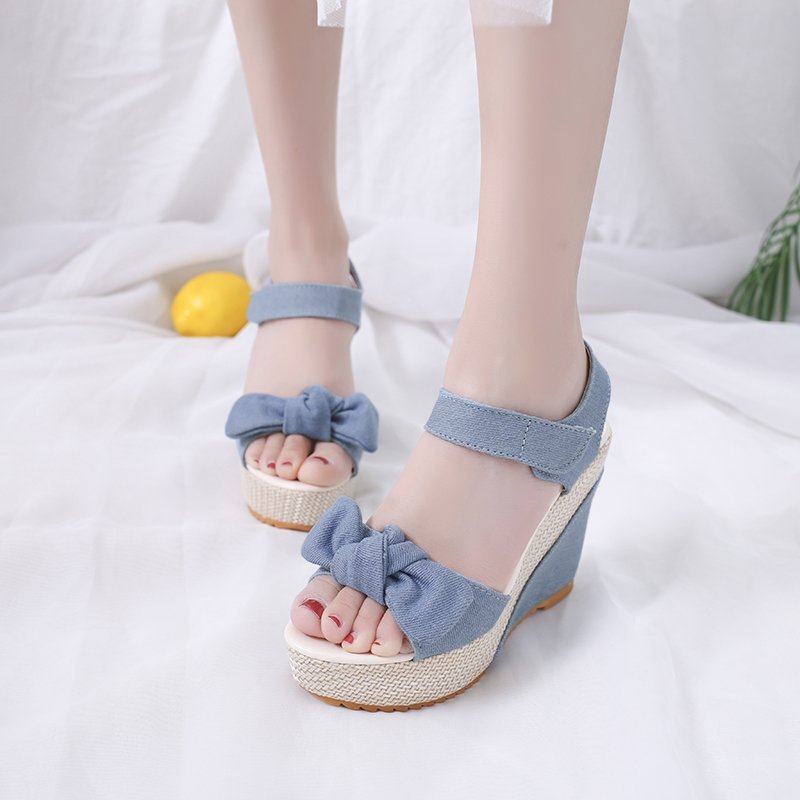 Summer fashionable cute sandals with a strap with bow wedge heel…