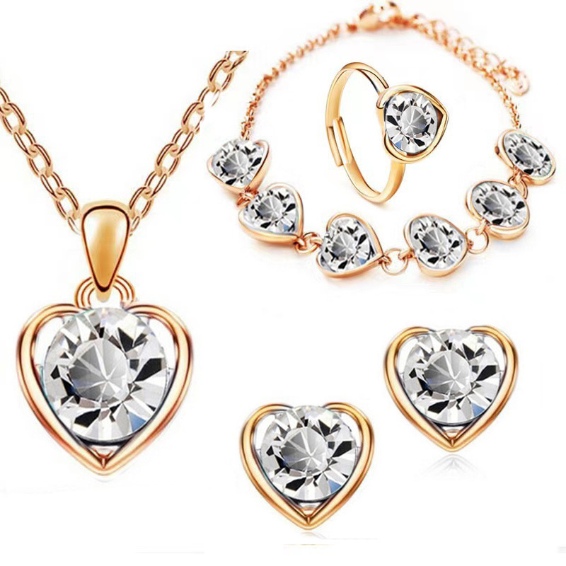 Venta caliente transfronteriza joyería en forma de corazón de cristal traje personalidad femenina temperamento corazón collar pendientes anillo pulsera conjunto de cuatro piezas