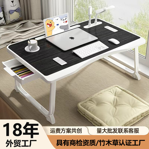 Folding the mobile lifting laptop computer table beside bed