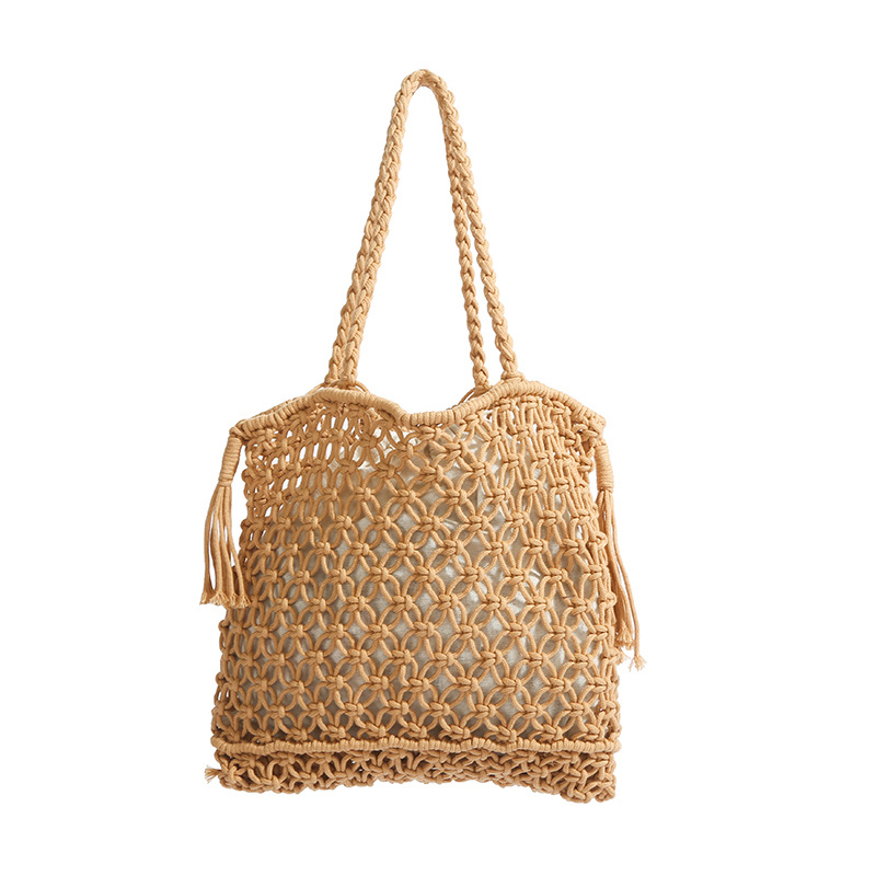 Versión coreana del bolso de nicho 2025 verano nuevo bolso femenino bolso tejido hueco bolso de hombro con borla de gran capacidad