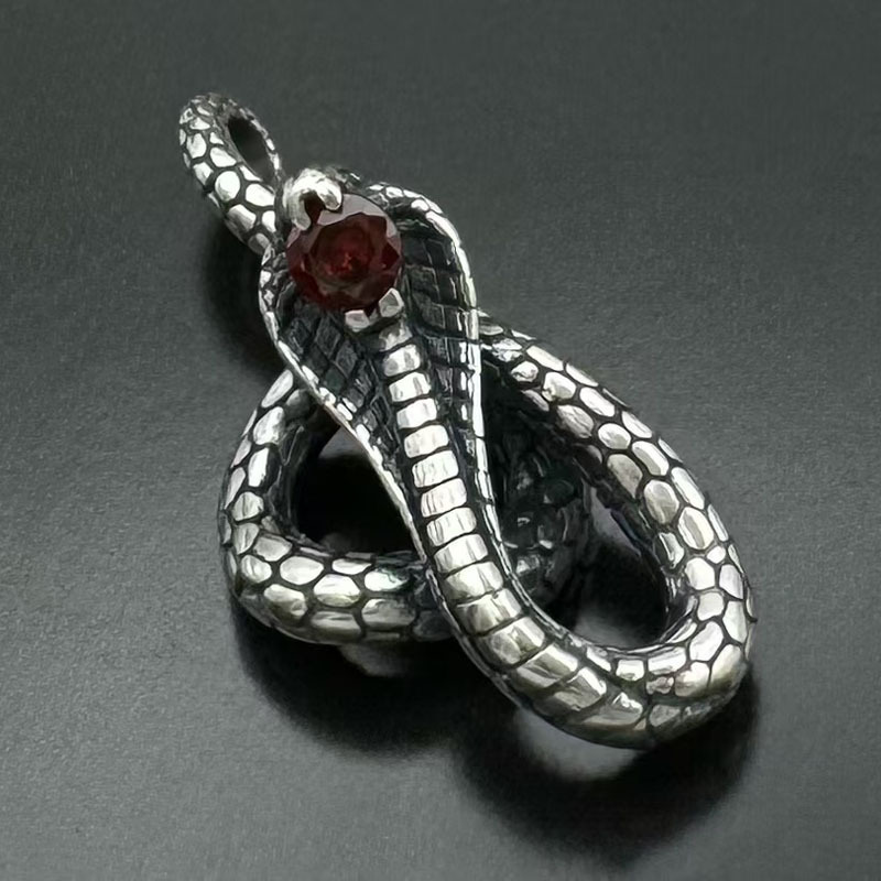 Angled top-down view of the coiled serpent amulet