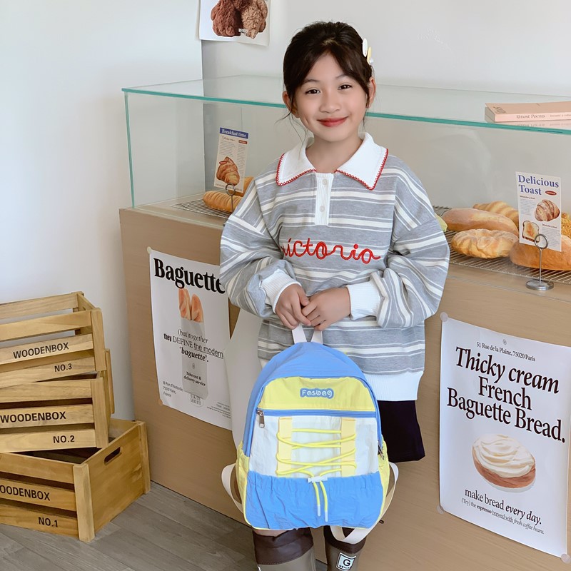 Mochila deportiva de ocio para niños y niñas, mochila de estudiantes de escuela primaria de gran capacidad de aire extranjero 2025 mochila infantil de cuerda de color contrastante