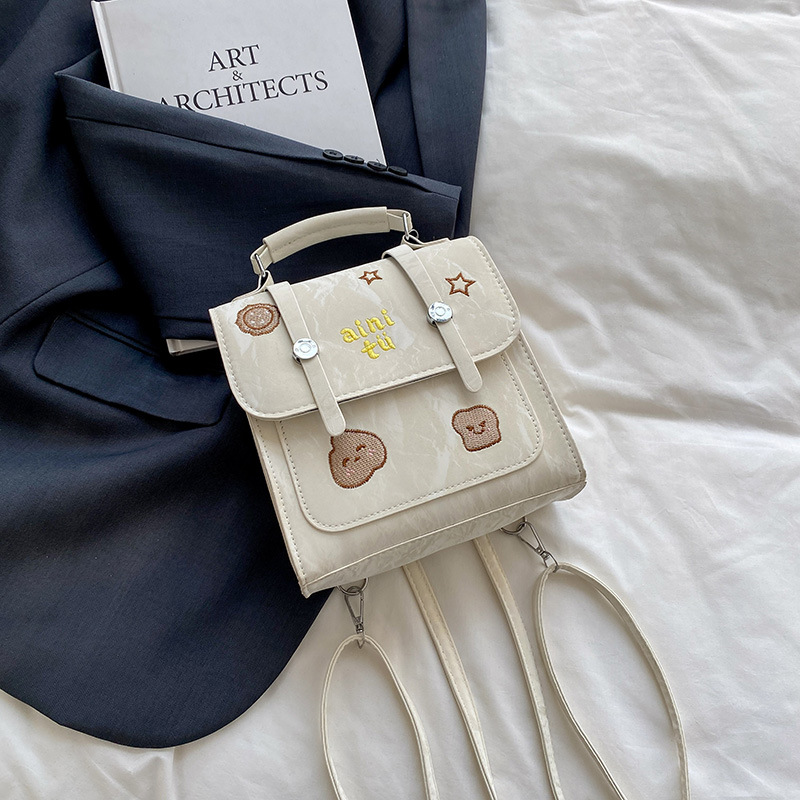 Bolsa universitaria viento rojo para mujeres 2025 nueva moda alta sensación de mochila de viaje universal mochila