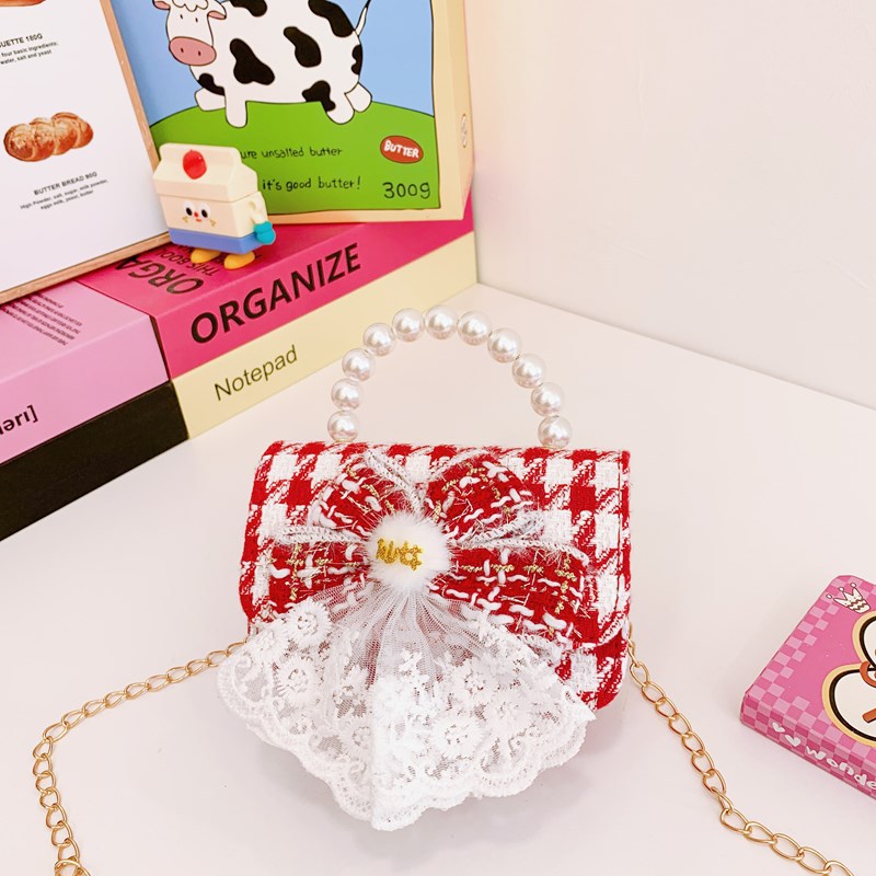 Nuevo bolso de hombro de niñas lindo arco bolso de perla bebé 2025 bolso rojo pequeño viento perfumado bolso para niños