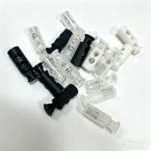 塑料尼龙染色双孔圆柱型弹簧扣防晒服黑白色透明松紧穿绳调节锁扣