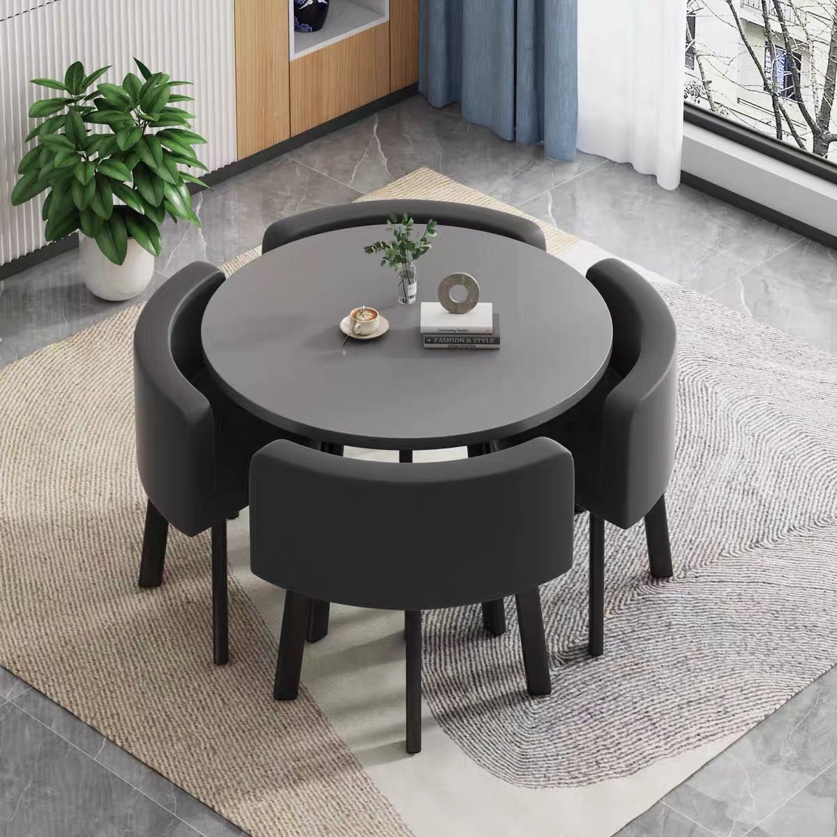 Gray round table + four black leather chairs