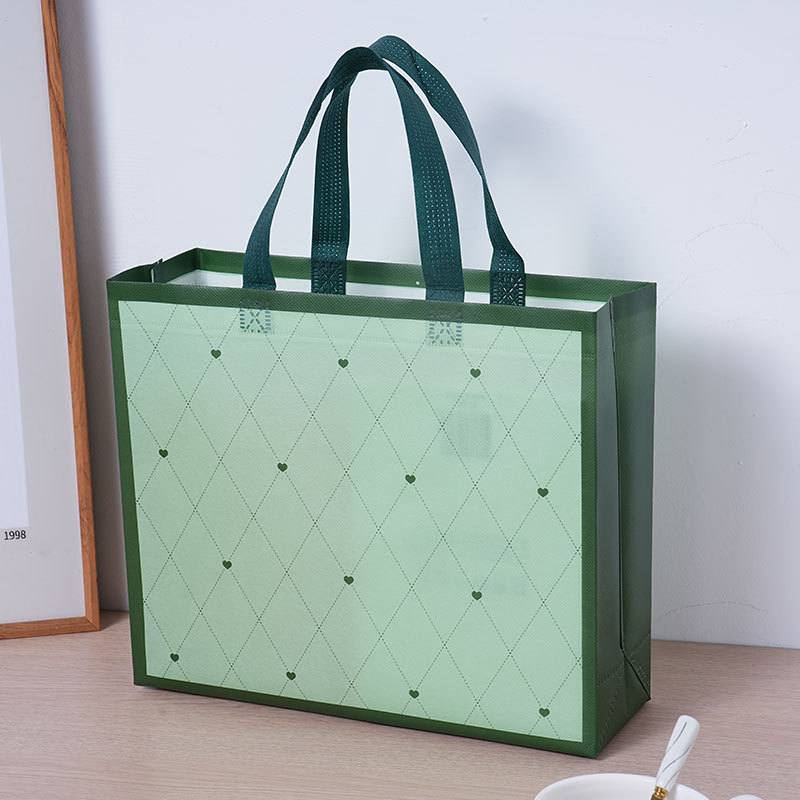 Bolsas de tela no tejida cubiertas de amor verde personalizadas atmósfera simple de alto valor de color bolsas de hombres y mujeres clásicas impermeables engrosadas