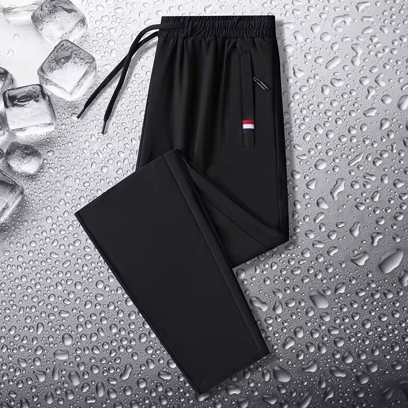 Camisas y menos ropa, pantalones de seda de hielo, pantalones de chándal elásticos finos de verano, pantalones rectos de hombre con cremallera de bolsillo al por mayor al por mayor