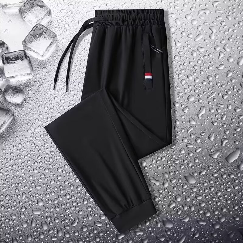 Camisas y menos ropa, pantalones de seda de hielo, pantalones de chándal elásticos finos de verano, pantalones rectos de hombre con cremallera de bolsillo al por mayor al por mayor