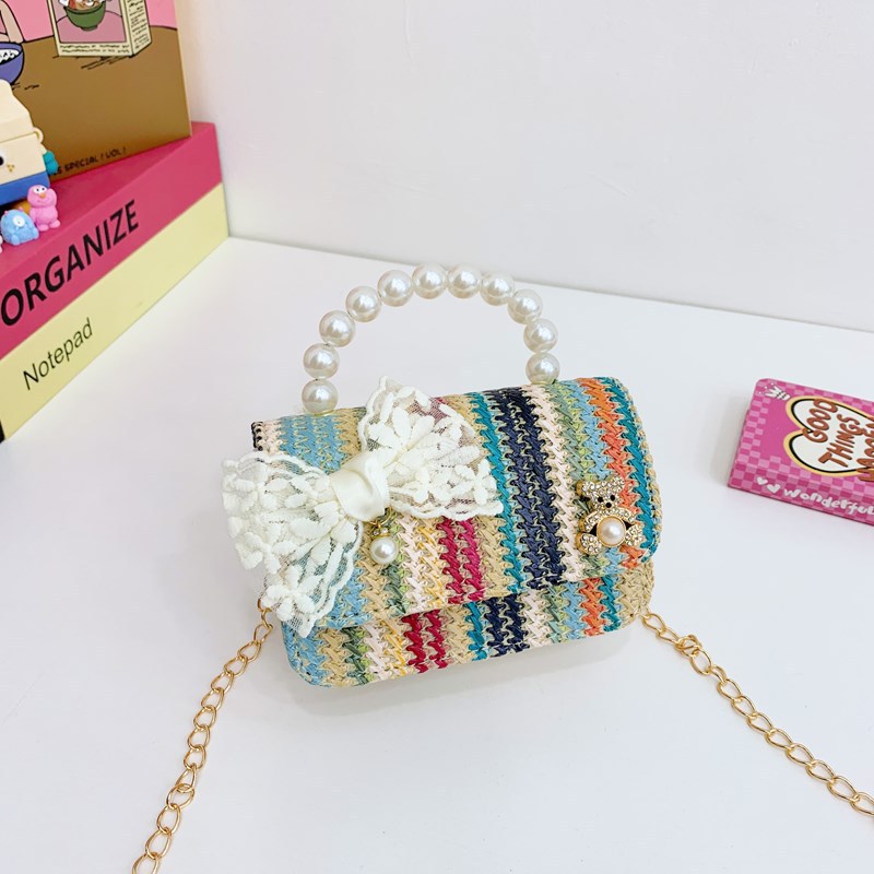 2025 verano nuevo arco de paja bolsa de perla portátil inclinada pequeña fragancia bolsa de moda para niños mochila para niñas