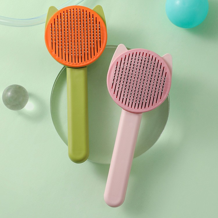 Peine para mascotas con orejas de gato Peine de aguja de acero de belleza con una tecla Peine para perros y gatos Productos para mascotas ABS de alta calidad