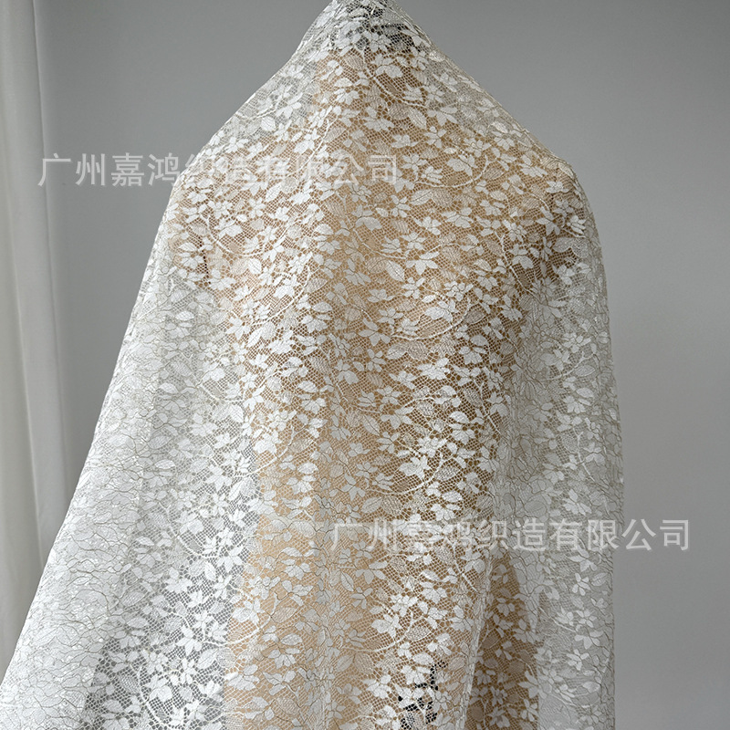 Tejido de encaje de nylon brillante oro francés temperamento de mujer falda flor de encaje fábrica de stock
