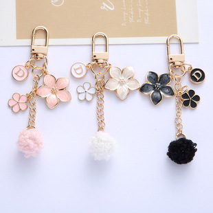 New personalized flower letter fur ball keychain phone case pendant fresh simple earphone case bag decoration