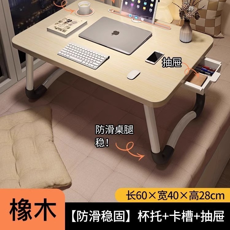 折り畳み可能なベッドの上の小さなテーブルは机のノートパソコンのテーブルを勉強します。|undefined