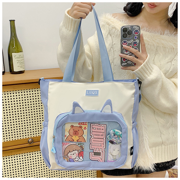 The new cute cartoon printed student bag with a large capacity and transparent student storage single-shoulder bag is selling well for women undefined