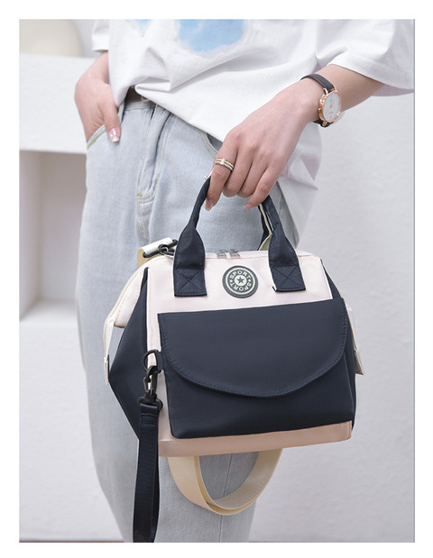The Mommy bag is small and cute. It has a detachable front pocket and is a multi-functional baby bag. It is waterproof, lightweight, and has a crossbody design. It can be used to carry milk bags undefined
