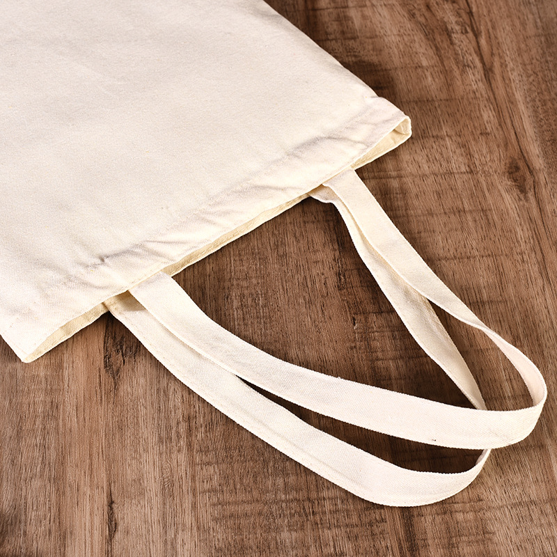 En stock bolsa de lona portátil en blanco personalizable logotipo de impresión en color de un solo hombro bolsa de compras bolsa de algodón de entrenamiento publicitario