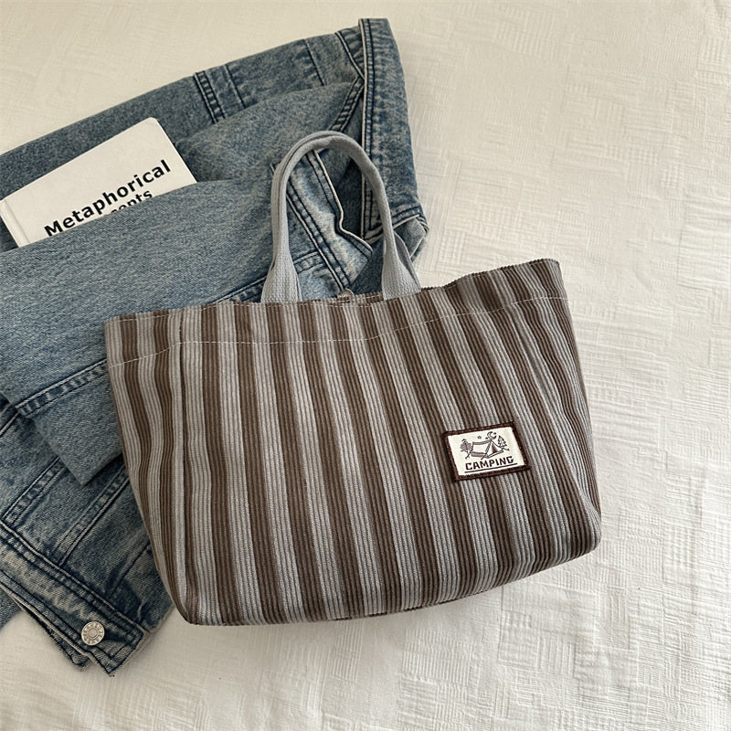Bolso tote de tela a rayas de estilo europeo y americano, nuevo bolso pequeño de moda, bolso femenino portátil, bolso de almuerzo de mano, bolso de bocadillos