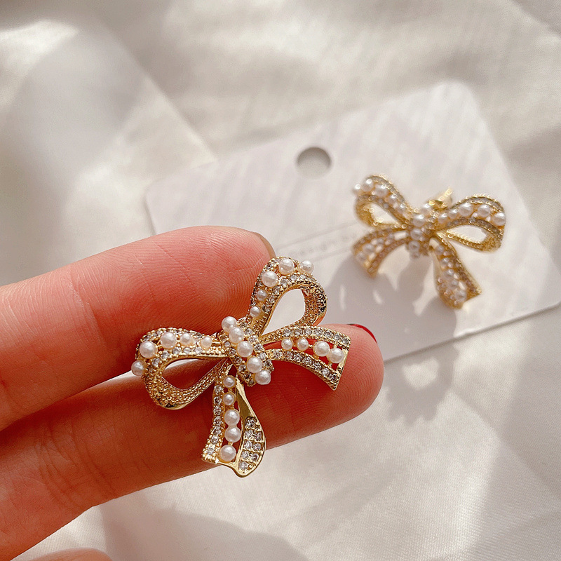 Micro-inlaid Pearl Bow Earrings display picture 6