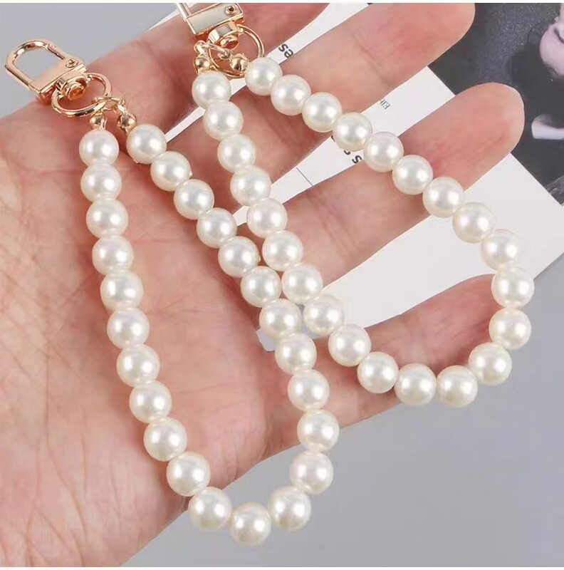 Factory direct key chain door buckle mobile phone pendant diy imitation pearl small short bag wallet doll hand chain wholesale