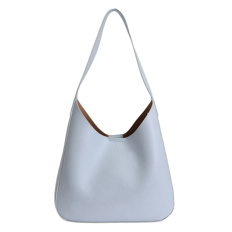 Nicho de diseño simple bolso de cubo portátil para mujeres 2026 primavera nueva moda perezosa retro bolso de brazo diario