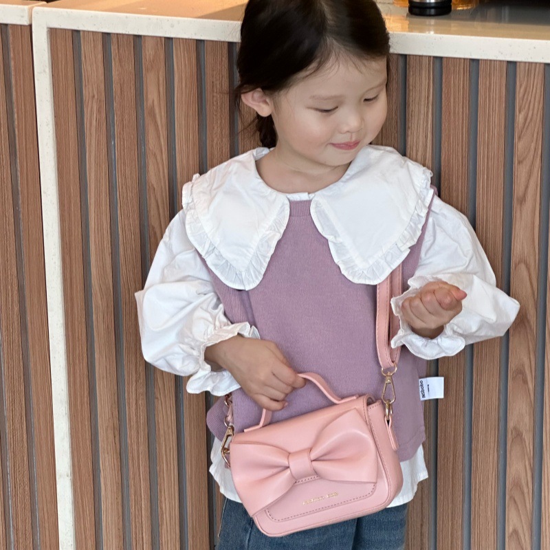 2025 nuevo bolso para niños mini accesorios para niños bolsos de mano simple color sólido arco extranjero bolso de hombro para niñas