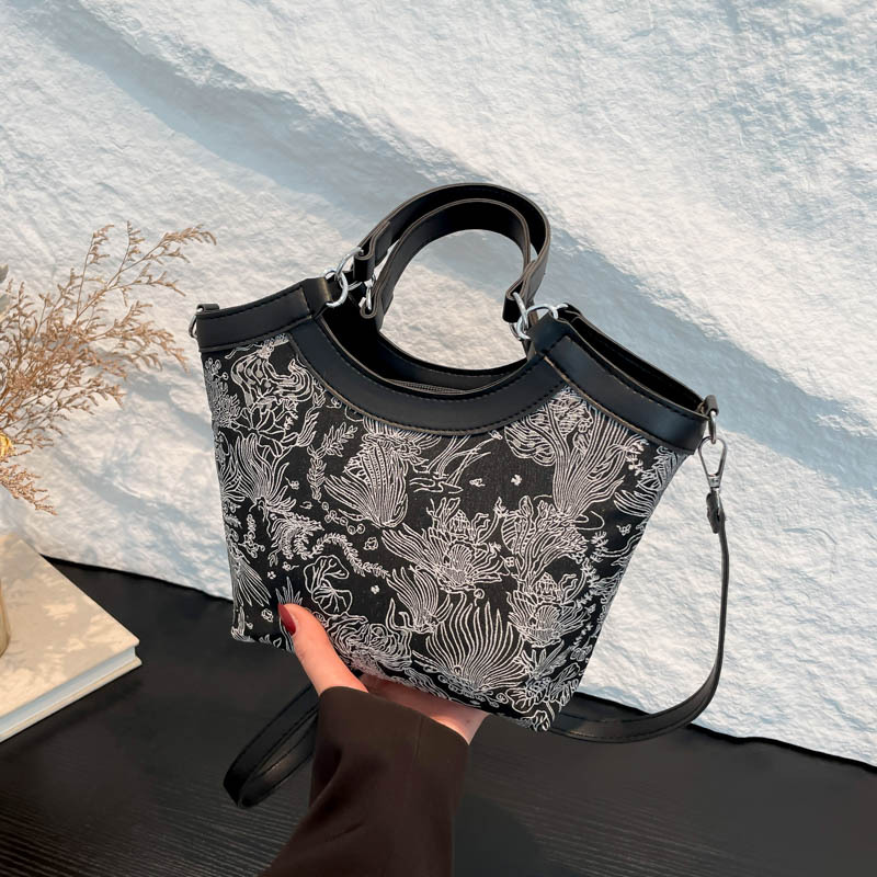 Nueva bolsa de mano de estilo chino para mujeres 2025 primavera nueva seda bordada de hombro único bolso de cubo de estilo occidental