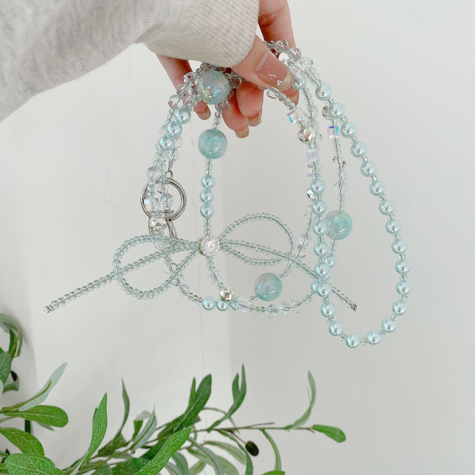 Boutique hecho a mano cadena colgante de alta gama arco fresco de cuatro colores cadena larga cordón de teléfono móvil de moda mensajero largo/colgante