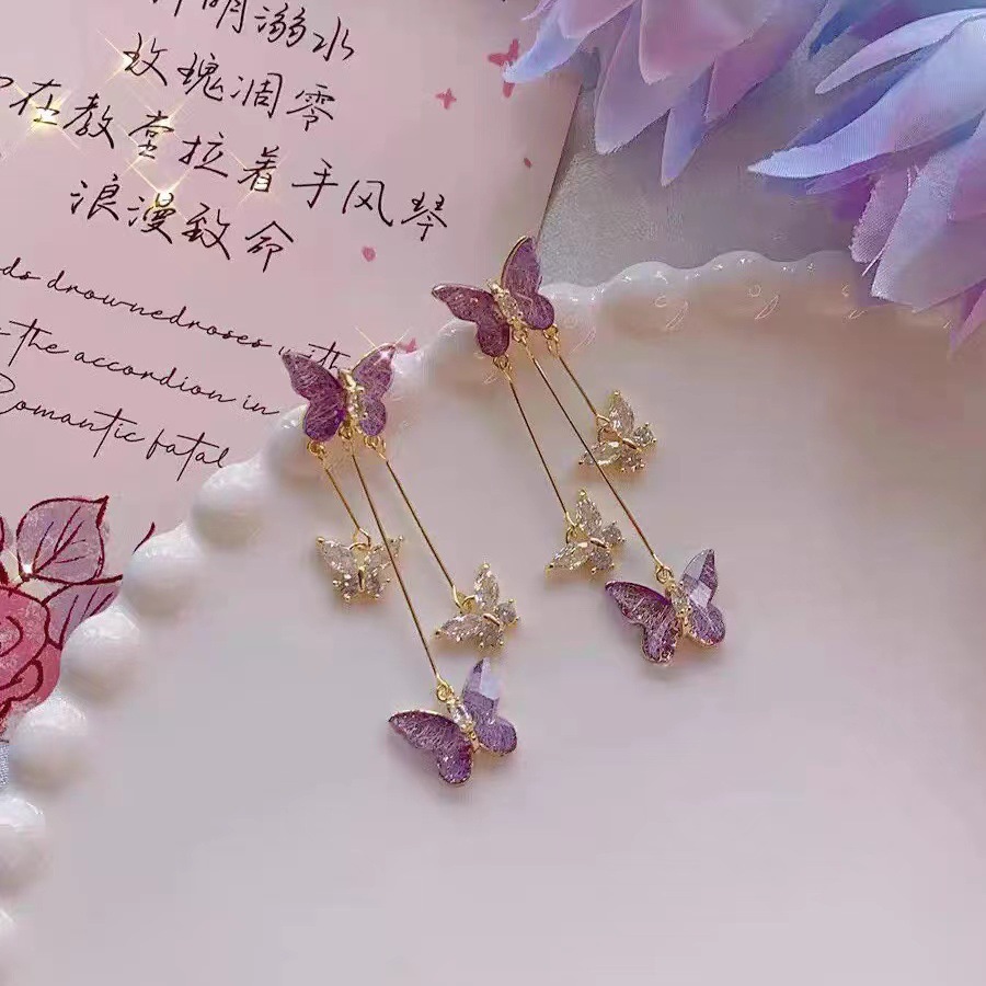 Pendientes de diseño de nicho de moda y exquisito todo fósforo Pendientes de temperamento de hadas Pendientes de borla de mariposa de cristal púrpura