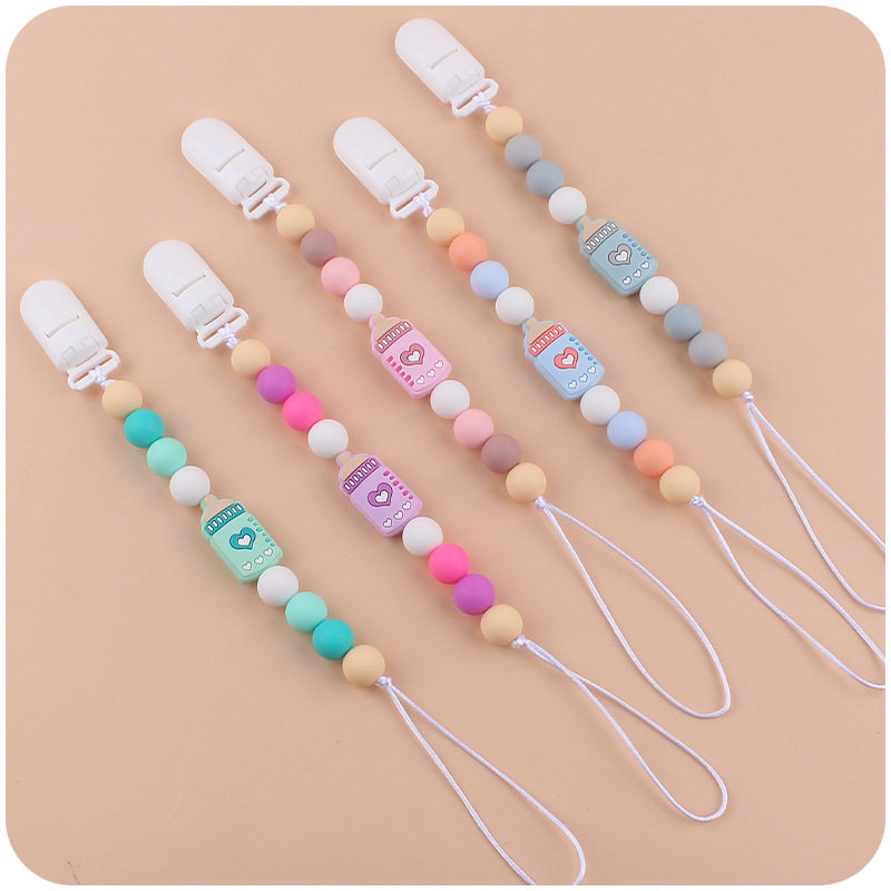Nuevos suministros de bebé biberón de dibujos animados pequeño mordedor calmante bebé DIY cuentas de silicona mordedura molar Cadena de pezón