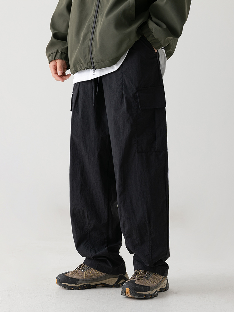 Textura ligeramente arrugada, pantalones de herramientas funcionales antisalpicaduras, estilo de primavera para hombres, pantalones casuales con cordón plisado suelto al aire libre japonés