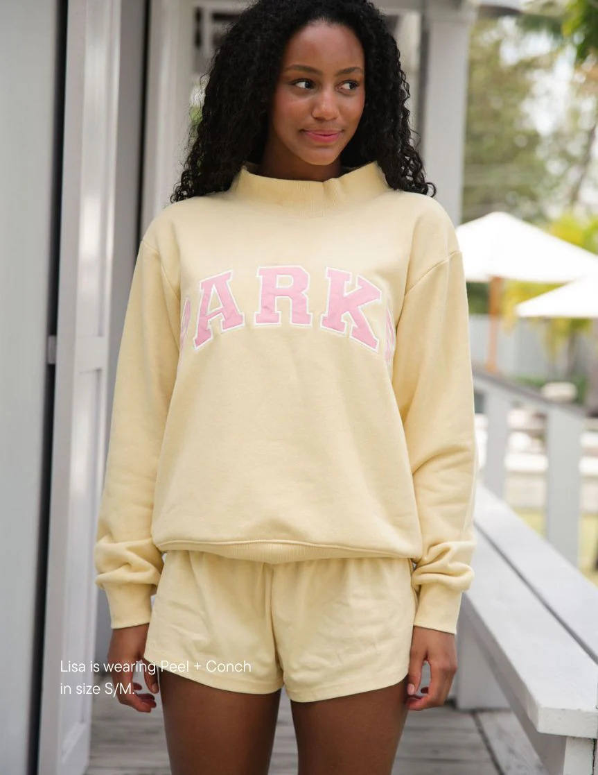 Khaki turtleneck-pink lettering