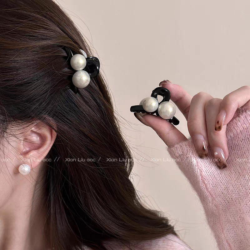 A pair of bright white large and small bead grippers