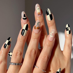 Black and white checkered pumpkin Halloween nail art with a moon hat and fake nails, almond-shaped nails, wholesale nail stickers