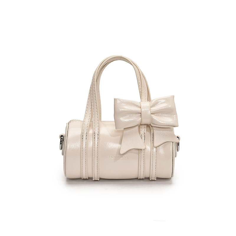 Bolso cilíndrico para niña de color sólido simple bolso de bebé con lazo dulce y lindo 2025 moda mini bolso para niños