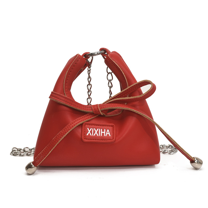 Bolsa de tendencia coreana para niñas, mini bolso de mano simple de color sólido, bolso de accesorios para niños de arco lindo