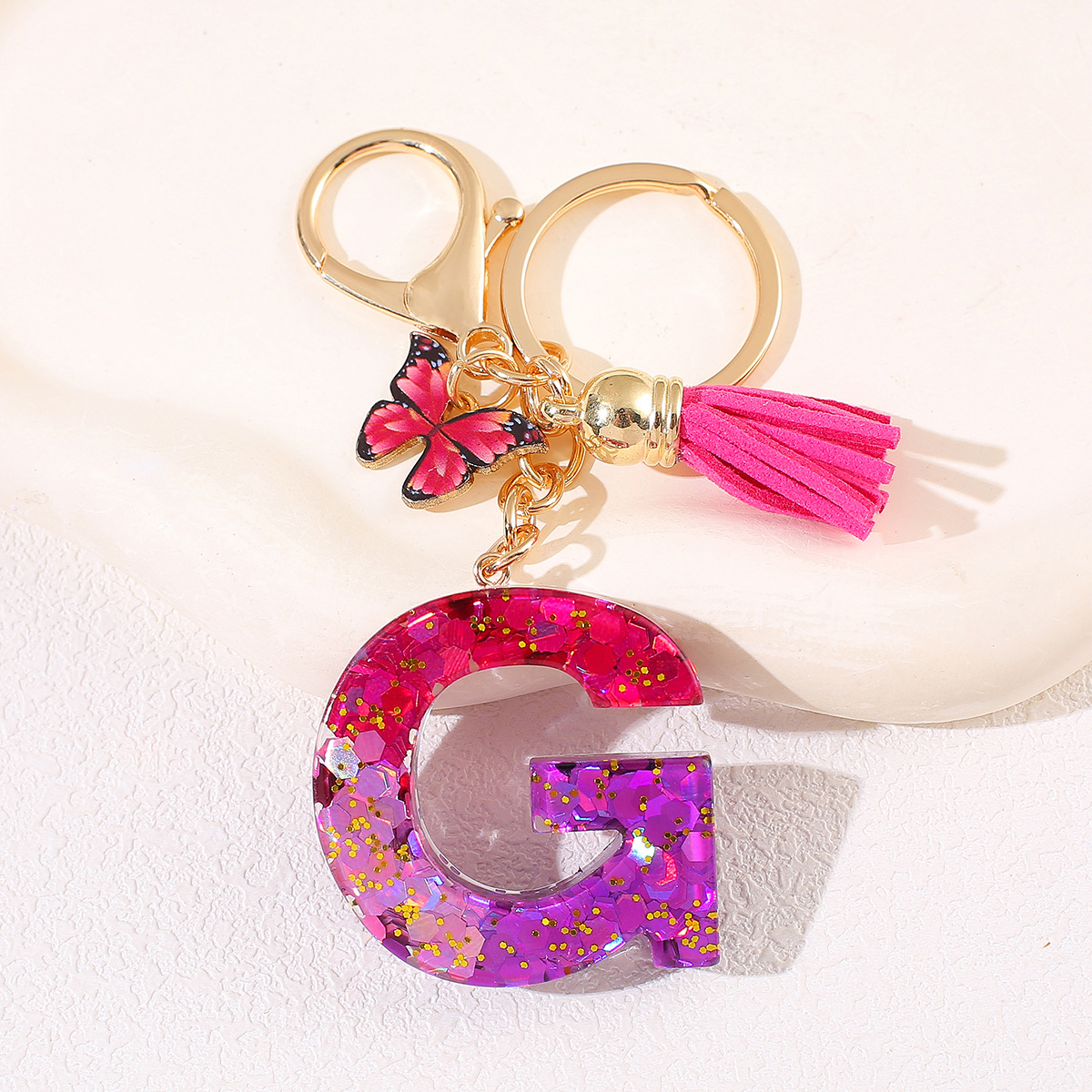 Transfronterizo Amazon 26 letras llavero de goteo de goma esquinilla gradiente letras mariposa llavero bolso de mujer colgante