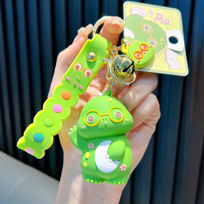 Keychain dinosaurio auténtico lindo bolso colgante de goma blanda llavero de automóvil muñeca pequeña máquina de regalos al por mayor image 6
