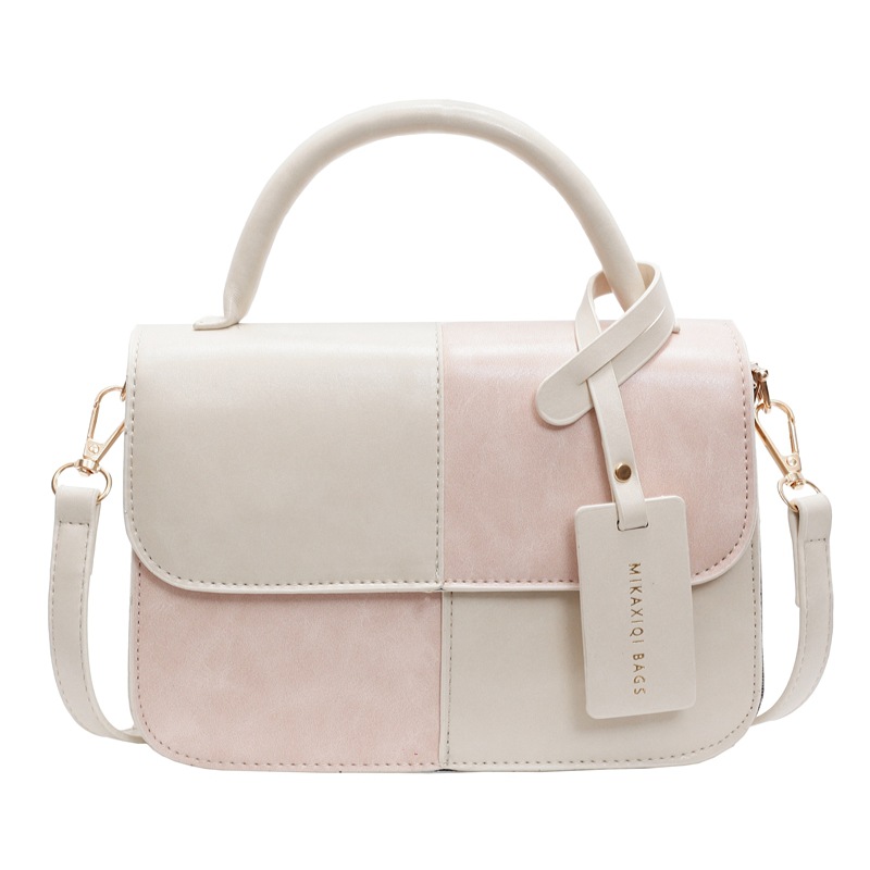 Bolso de mano coreano de color para mujeres 2025 nuevo nicho de textura universal bolso de hombro simple mochila casual