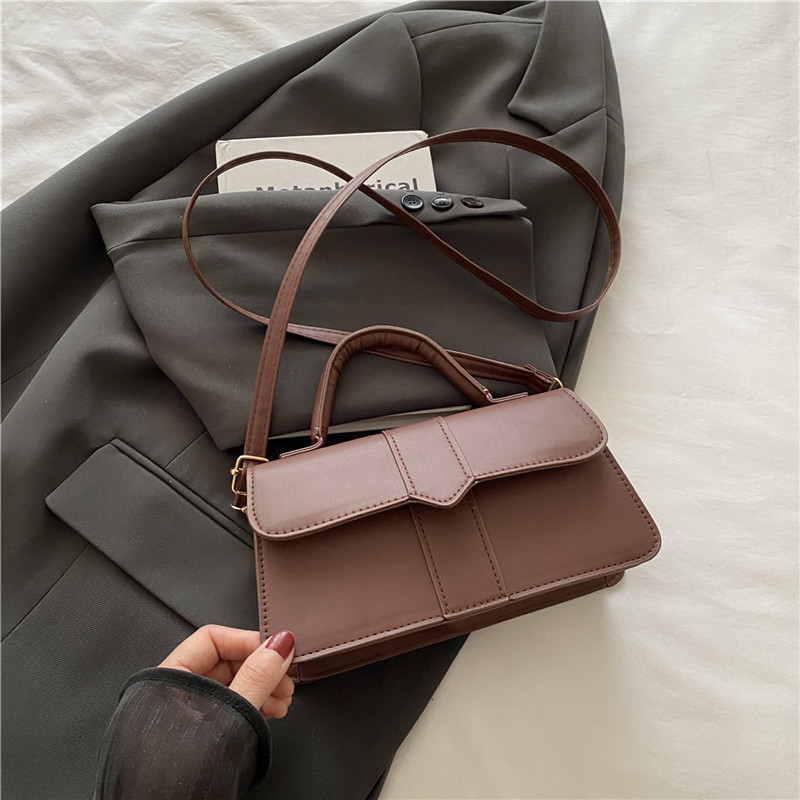 Bolso de color sólido de diseño de nicho para mujer 2025 nuevo bolso cuadrado portátil de moda de moda bolso de mensajero de alta gama de todo fósforo